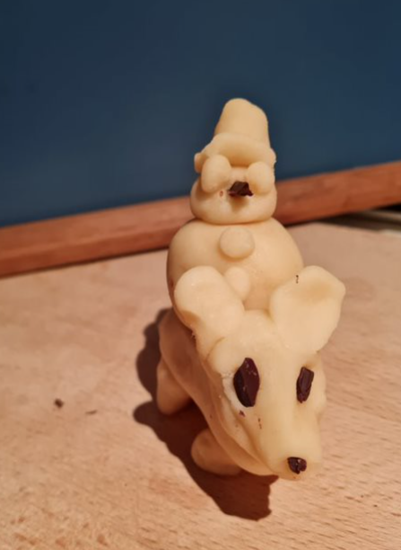 Photo of a marzipan snowman riding a marzipan rat thingie