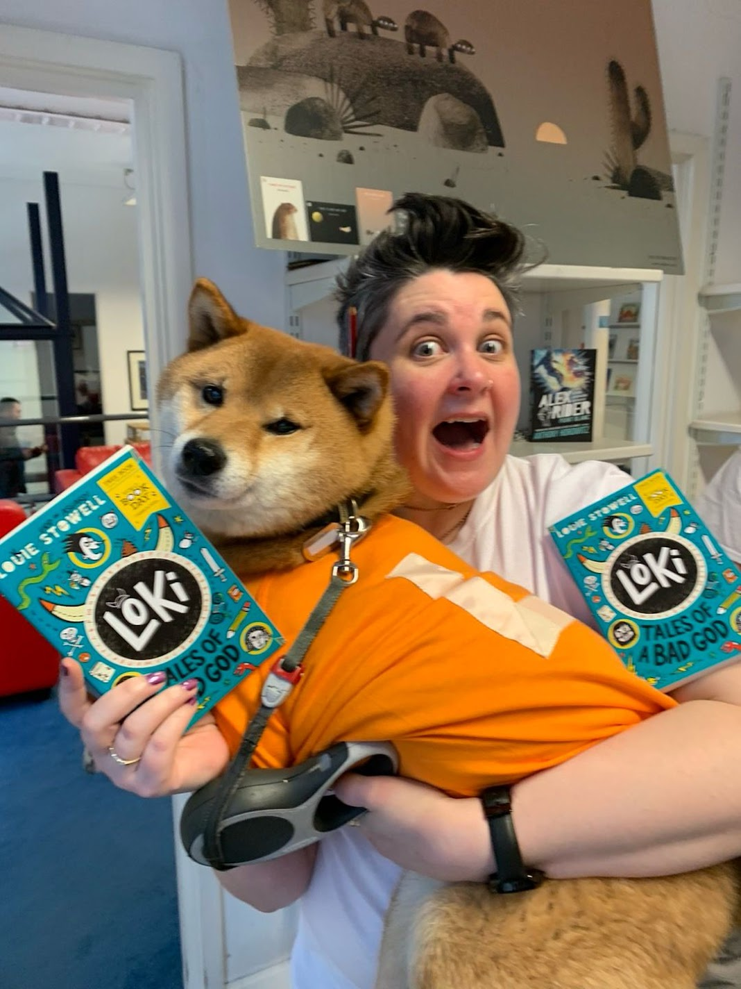 Non Pratt dressed as Loki holding a dog also dressed as Loki plus a couple of copies of my World Book Day Book